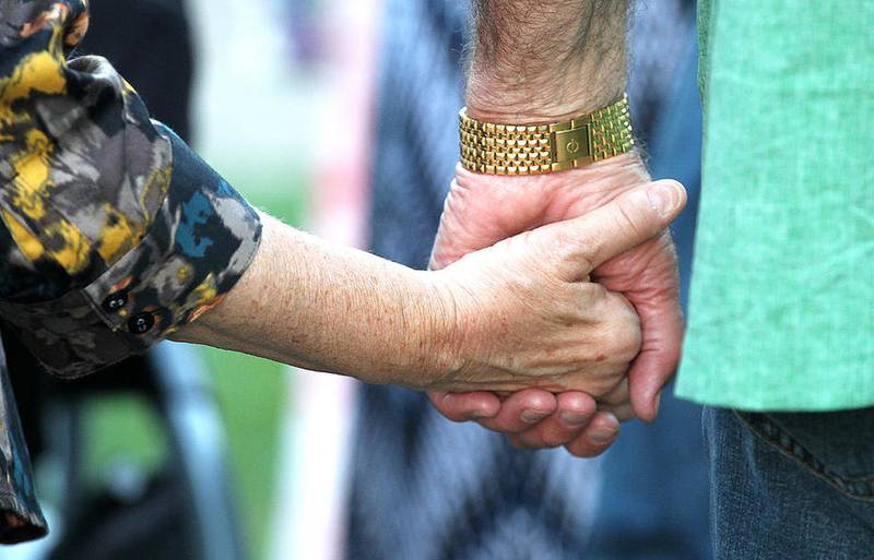 H. Rick Bamman - hbamman@shawmedia.com  
A couple holds hands Wednesday, Oct. 5, 2016 during the Turning Point Candlelight Vigil on the Woodstock Square.