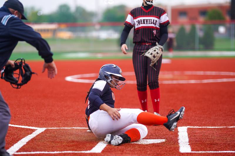 Oswego’s Aubriella Garza (12) slides into home for a score against Yorkville during a softball game at Yorkville High School on Thursday, May 9, 2024.