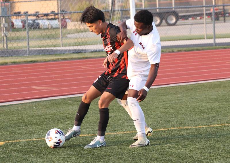 DeKalb's Mauricio Jasso (left) holds off Rockford East's Oredi Kakozi during their game Thursday, Sept. 12, 2024, at DeKalb High School.