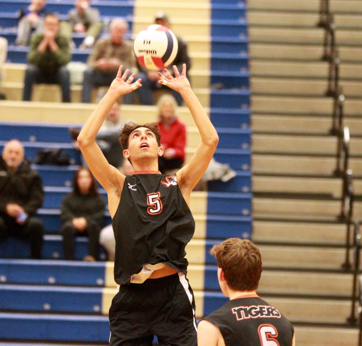 Wheaton Warrenville South’s Joseph Kelly sets the ball during a game at Geneva on Tuesday, April 2, 2024.