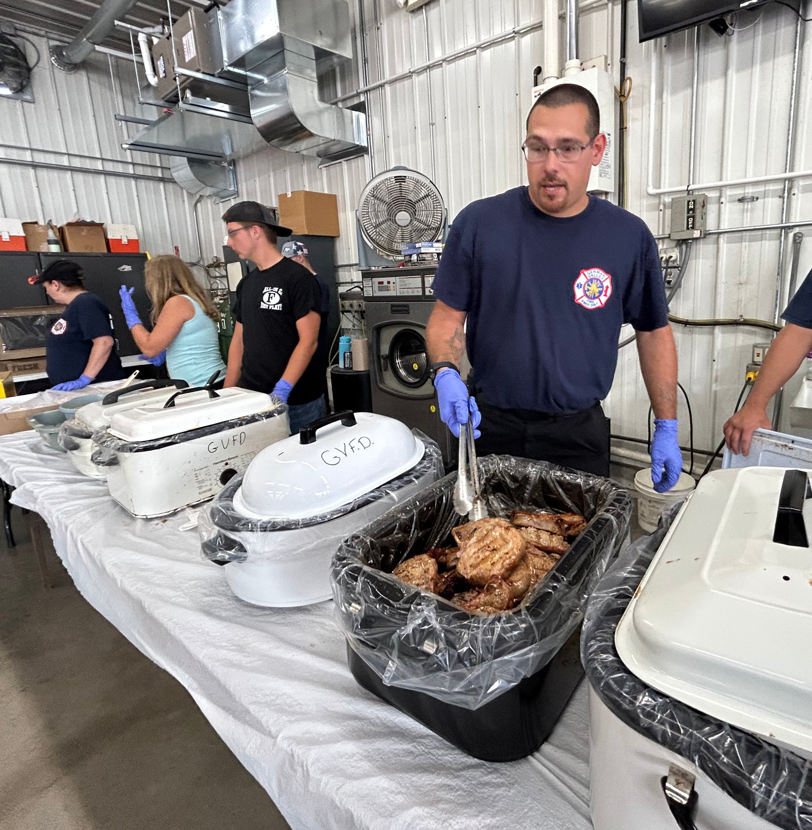 Hank Stromback was one of the firefighters helping at the department's annual pork chop dinner during German Valley Days on Saturday, July 20, 2024.