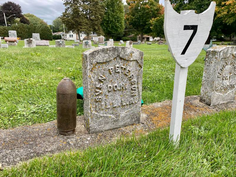 The gravestone of Sven B. Peterson, a Sycamore Civil War veteran who died in 1924 and served as a Private Corp. in the 1st Illinois Light Artillery Regiment. Next to his gravestone is a light artillery shell artifact. Peterson's life was shared at the DeKalb County History Center’s annual Etched in Stone Cemetery Walk at Elmwood Cemetery, 901 S. Cross St., Sycamore on Sunday, Oct. 8, 2023.