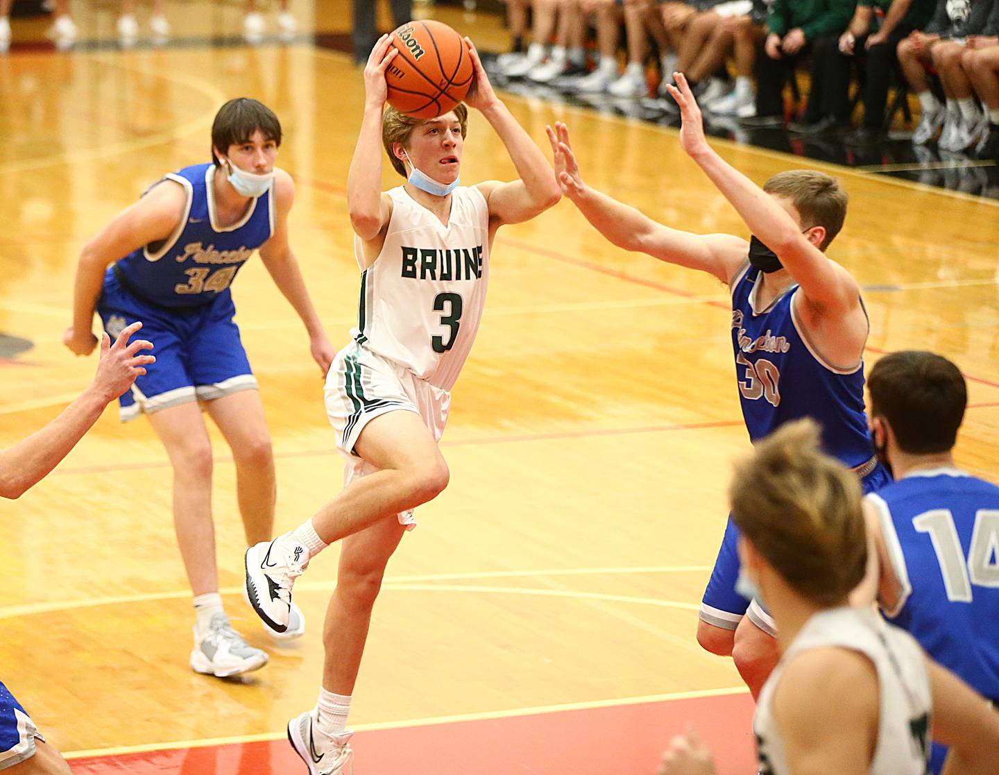 St. Bede’s Callan Hueneburg, (3) plows through the lane to score a layup over Princeton during the 47th Colmone Classic tournament on Tuesday Dec. 7, 2021 at Hall High School in Spring Valley.