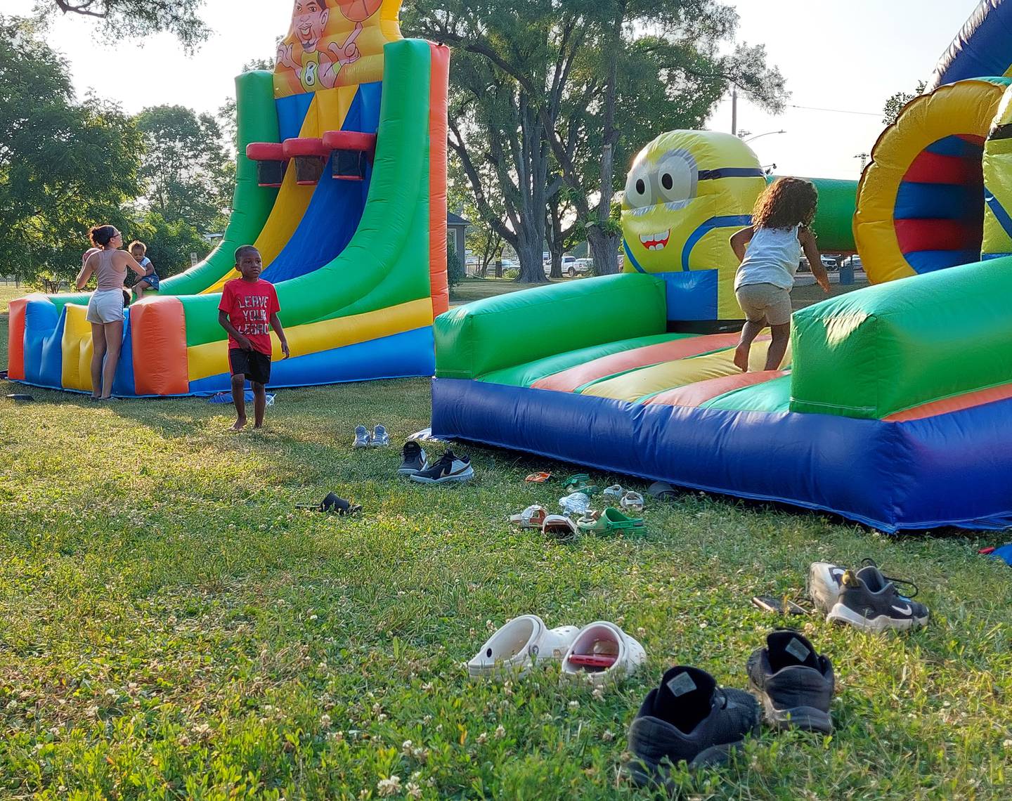 Children play at bounce houses Monday, June 19, 2023, during the Juneteenth celebration at Kirby Park in Spring Valley.