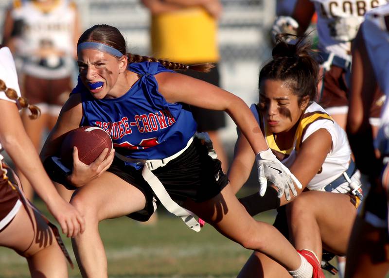 Dundee-Crown’s Kerrigan Svec runs the ball Jacobs’ in varsity flag football on Tuesday, Sept. 3, 2024, at Dundee-Crown High School in Carpentersville.