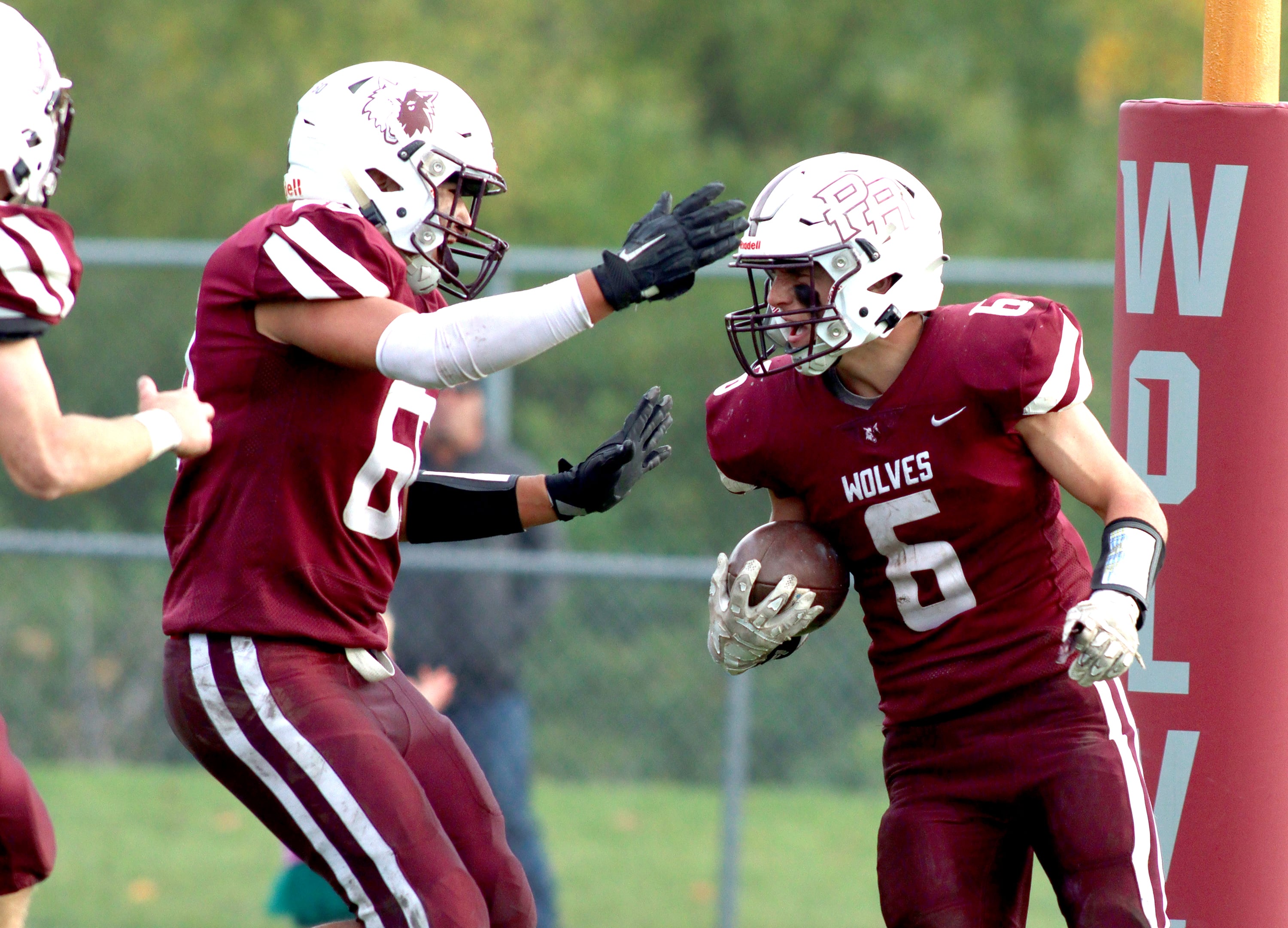 Prairie Ridge’s Luke Vanderwiel, right, is greeted in the end zone after a touchdown against Nazareth in first-round Class 5A playoff football action at Crystal Lake Saturday.