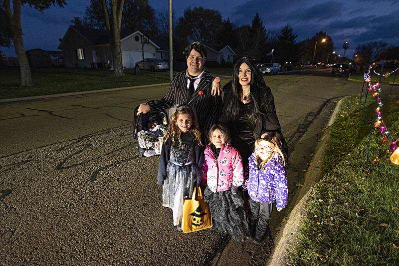 Lukus Warren stands with wife Angel and  Addlyin Bohm (left), 6, Lexi Warren, 5, and Laci Warren Tuesday, Oct. 31, 2023 while trick or treating in Rock Falls.