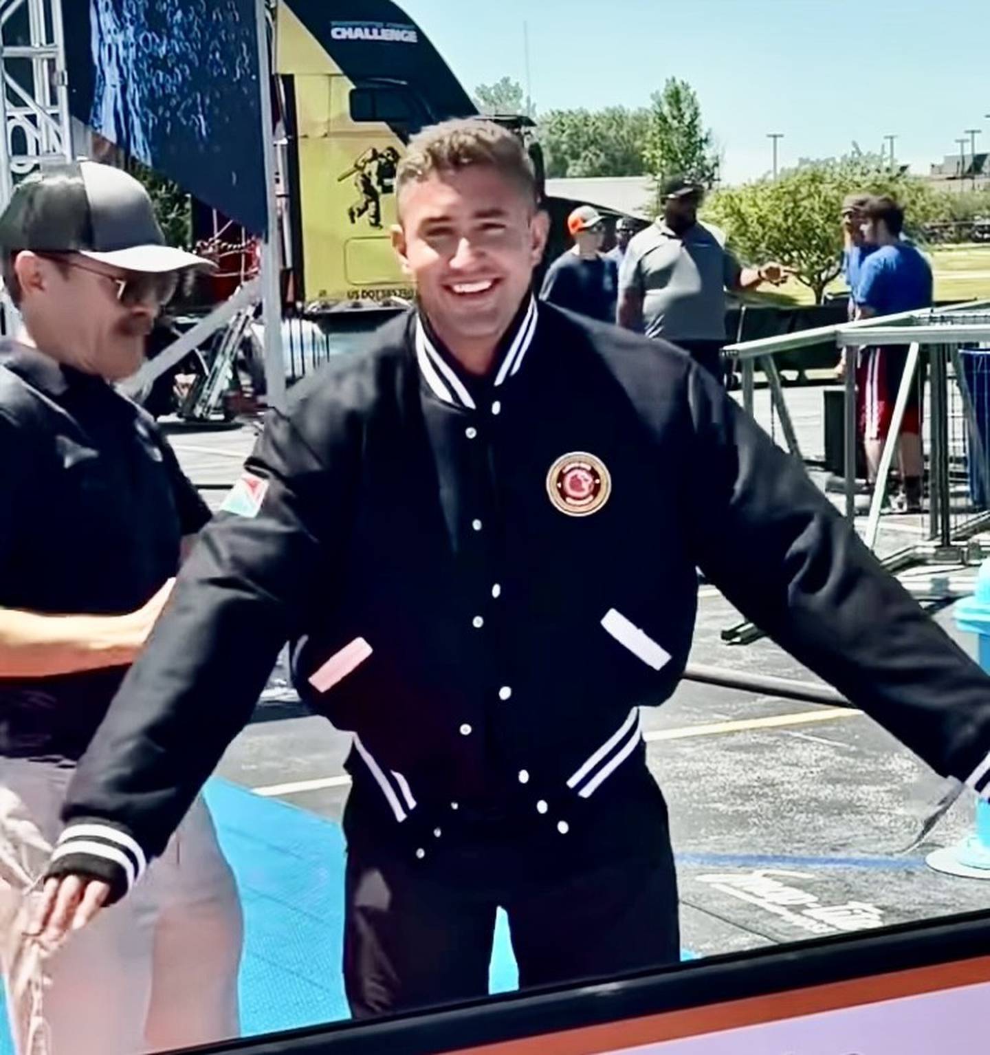 Princeton Fire Department Lieutenant Eli VanAutreve tries on his Lion's Club Letterman's Jacket after earning a spot in the coveted Firefighters' Challenge club competing at the Midwest Regional.