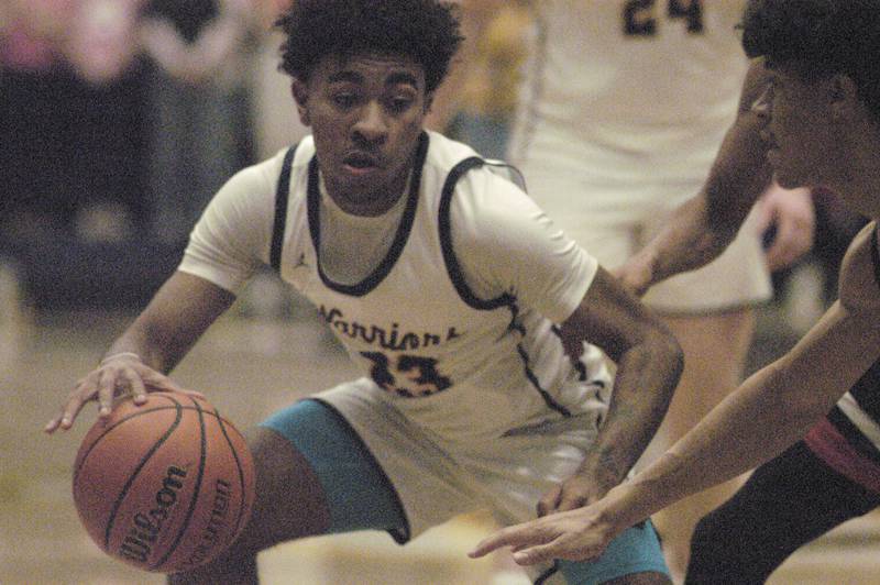 Sterling's Kaedon Phillips brings the ball up against United Township defensive pressure during their game Friday, Feb. 9, 2024 at Sterling High School