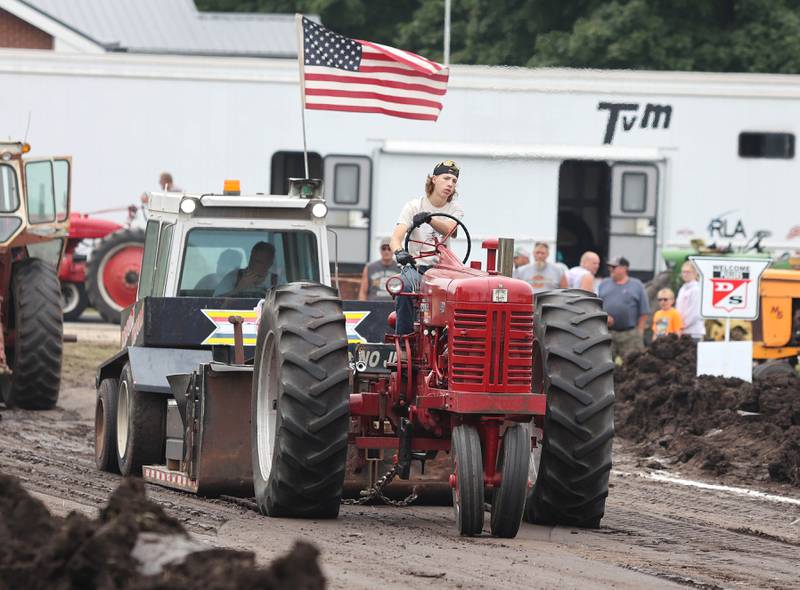 Tyler Brinkmeyer, 17, from Belvidere, wins the 6500 farm stock division of the tractor pull atop a Farmall 400 Saturday, July 16, 2022, at the Waterman Lions Summerfest and Antique Tractor and Truck Show at Waterman Lions Club Park.