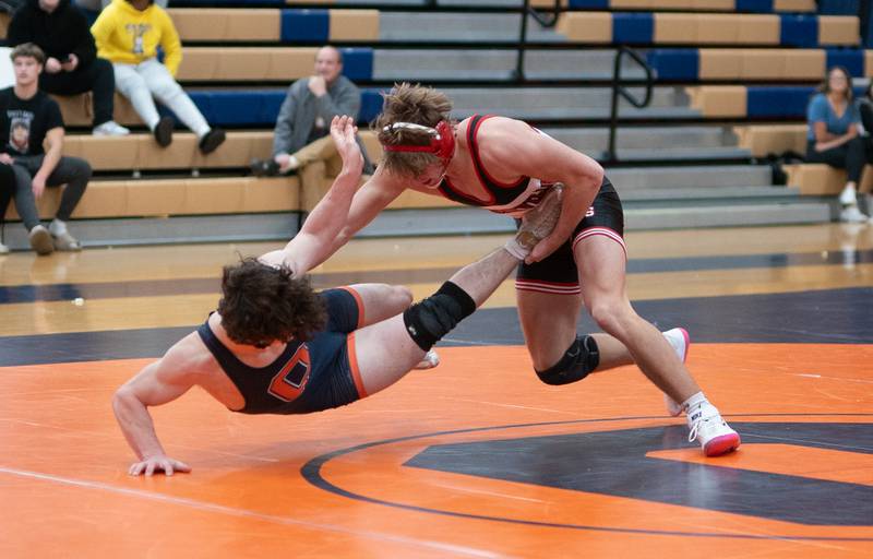 Yorkville's Luke Zook (right) shoots the legs of Oswego's Cooper Wynn in a 175 pound match during a wrestling meet at Oswego High School on Thursday, Dec 14, 2023.