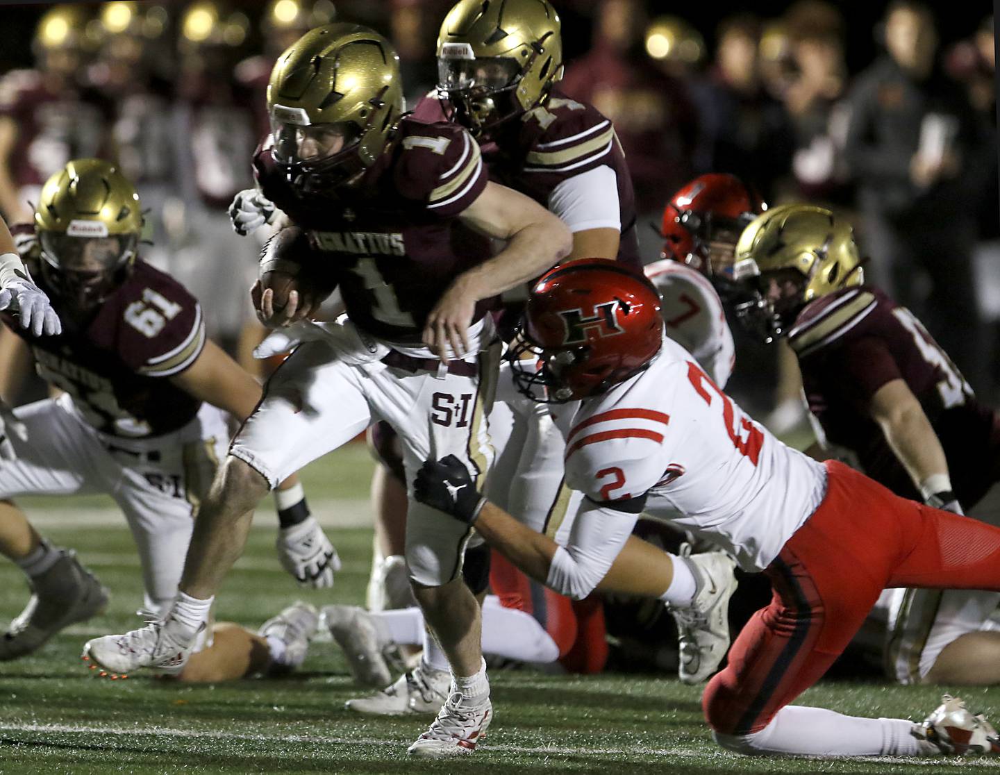 Huntley's Zack Garifo tackles St. Ignatius' Jack Wanzung during a IHSA Class 8A second round playoff football game on Friday, Nov. 3, 2023, at St. Ignatius College Prep in Chicago.