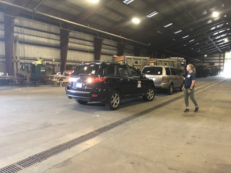 Bridget Hoffmann of the McHenry County Department of Health directs Veterans Path to Hope vehicles at Operation Dropbox June 11, 2024.