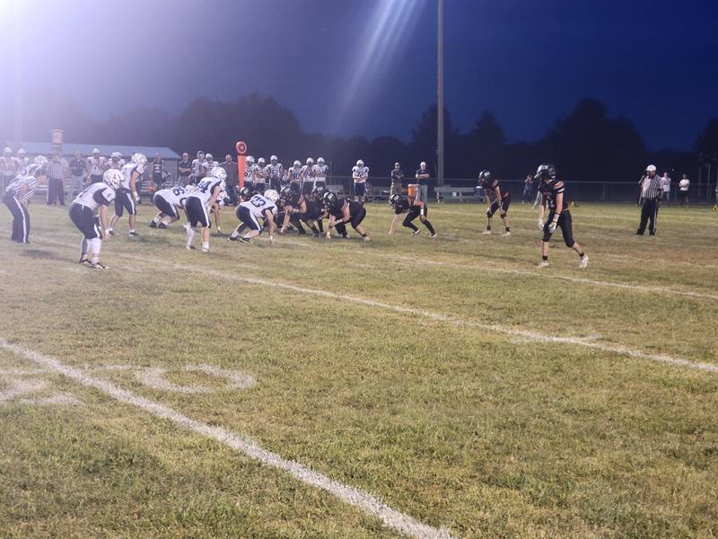 The Flanagan-Cornell/Woodland football gets ready to run a play during Friday's Illinois 8-man Football game against Ridgewood at the Wood Shed in rural Streator.