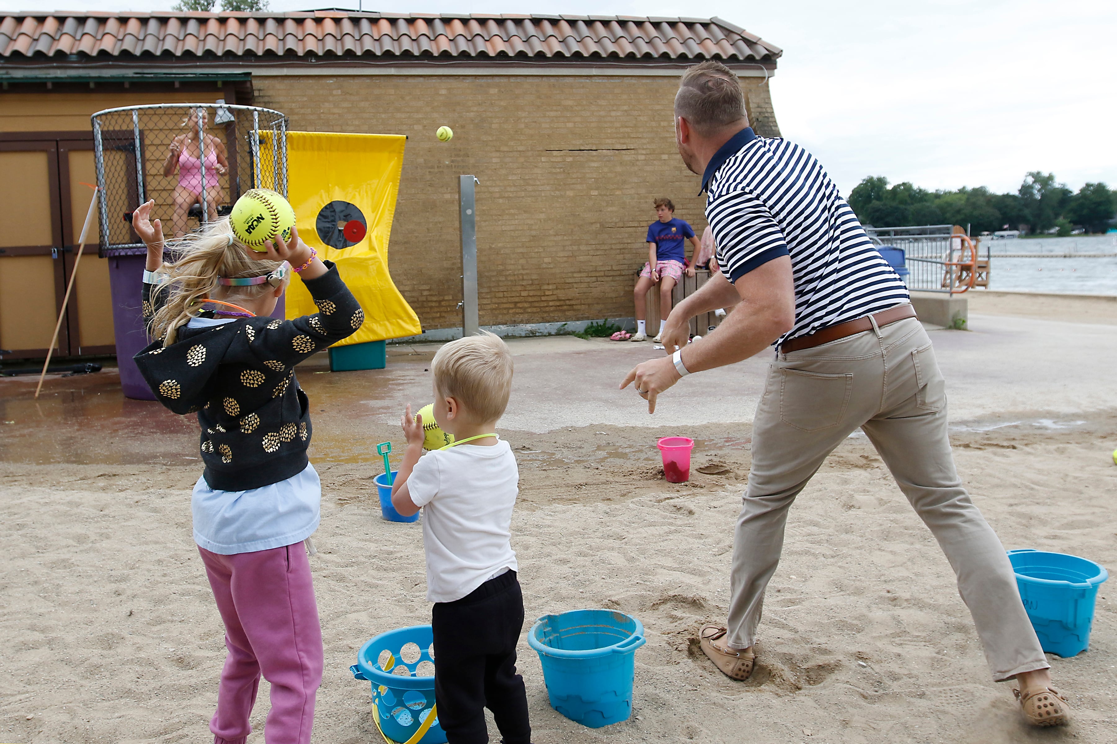 Matt Foster tosses a ball at the dunk tank as Miranda Alt during the Ice Cream Fest on Friday, Aug. 9, 2024, at Crystal Lake’s Main Beach.  The second annual event featured music, ice cream venders and an ice cream eating contest.