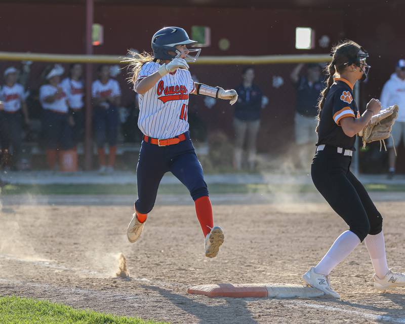 Oswego's Kaylee LaChappell (11) beats the throw at first during Class 4A Plainfield North Sectional semifinal softball game between Wheaton-Warrenville South at Oswego. May 29th, 2024.