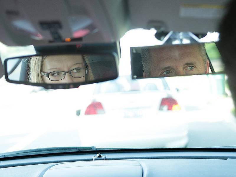 DeKalb sophomore Chloe O'Dell, 15, checks her mirror at a stop during her driving time Friday with DeKalb High School driver education instructor John Cordes in DeKalb.
