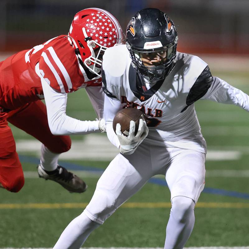 DeKalb’s Derrion Straughter tries to break away from Naperville Central's Nathan Monken during their game Friday, Oct. 6, 2023, at Naperville Central High School.