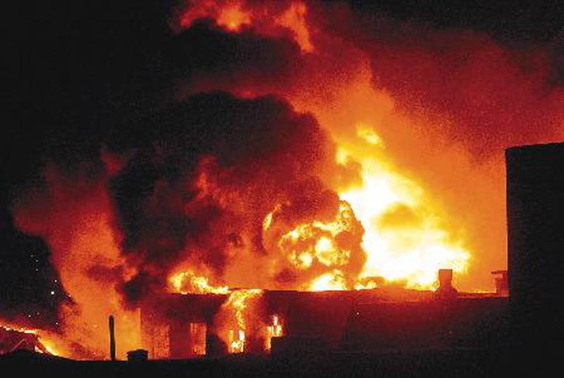 Flames shoot out of the Reliant Fastener factory in Rock Falls in 2007.