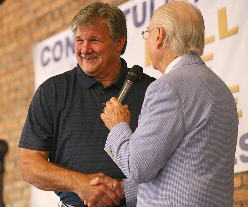 Inductee John Skibinski, shakes emcee Lanny Slevin hand before recieving his award the Shaw Local Illinois Valley Sports Hall of Fame awards on Thursday, June 2, 2022 at the Auditorium Ballroom downtown La Salle. Skibinski was drafted in the sixth round of the 1978 NFL Draft and played for the Chicago Bears from 1978-1981.