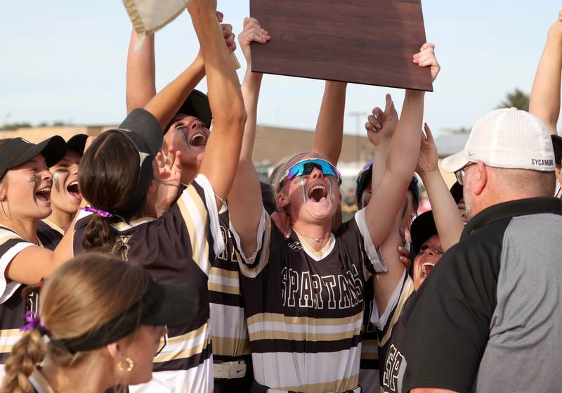 Sycamore players hoist the plaque after winning the Class 3A sectional final over Prairie Ridge Friday, May 31, 2024, at Sycamore High School.