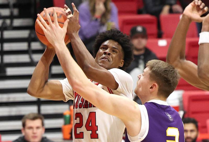 Northern Illinois Huskies guard Darweshi Hunter shoots over Albany Great Danes forward Trey Hutcheson during their game Tuesday, Dec. 20, 2022, in the Convocation Center at NIU in DeKalb.