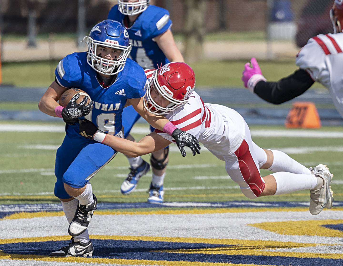 Newman’s Brady Grennan runs the ball against Hall's Jack Jablonski Saturday, Oct. 7, 2023 in Sterling.