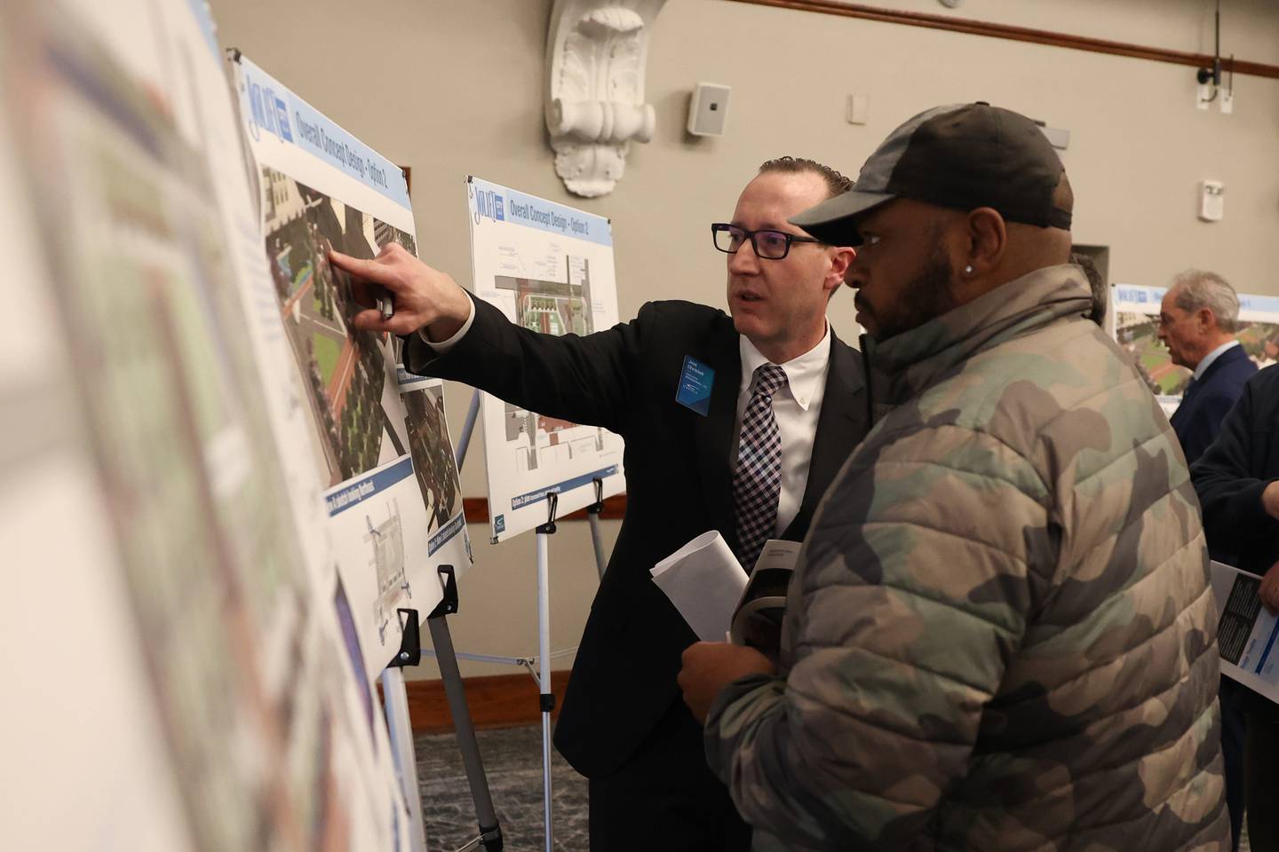 Joel Christell (left), of Civiltech Engineering Inc, goes over designs for the proposed plaza with Marzell Robinson, owner of Robinson’s Restaurant, during the City of Joliet downtown plaza open house at the Joliet Public Library on Thursday, February 23rd, 2023.