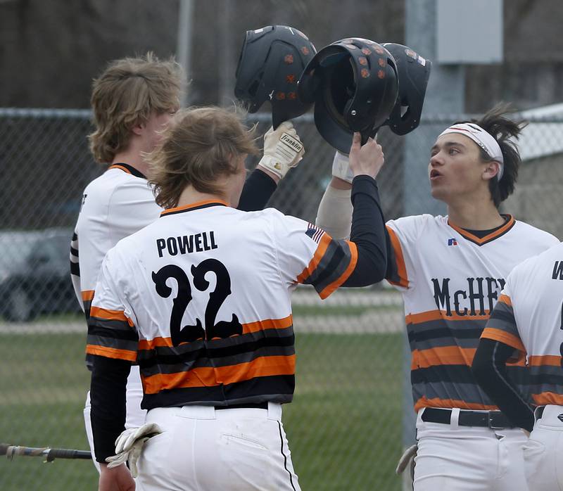 McHenry's Cooper Cohn celebrates with his teammates after hitting a three-run home run during a Fox Valley Conference baseball game Friday, April 15, 2022, between Jacobs and McHenry at Petersen Park in McHenry.