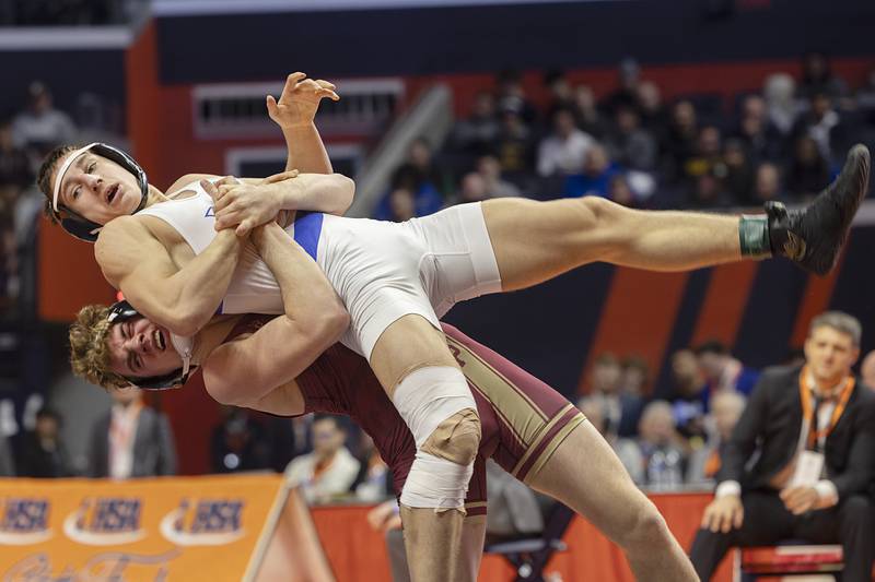 Vernon Hills’ Ilia Dvoriannikov is thrown by Dunlap’s Nick Mueller in the 2A 165 pound championship match Saturday, Feb. 17, 2024 at the IHSA state wrestling finals at the State Farm Center in Champaign.