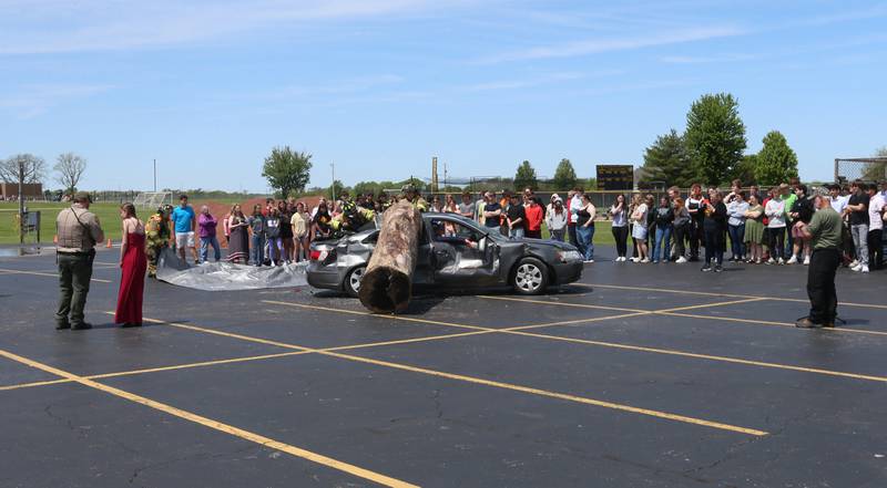 Putnam County High School students watch fire and ems personnel work a fake "mock prom" scene on Friday, May 3, 2024 at Putnam County High School.  Putnam County Fire and EMS units, PC Sheriff, and OSF Lifeflight crew conducted a drill crash scene. The school's prom is Saturday. The program helps students make good choices on prom night.