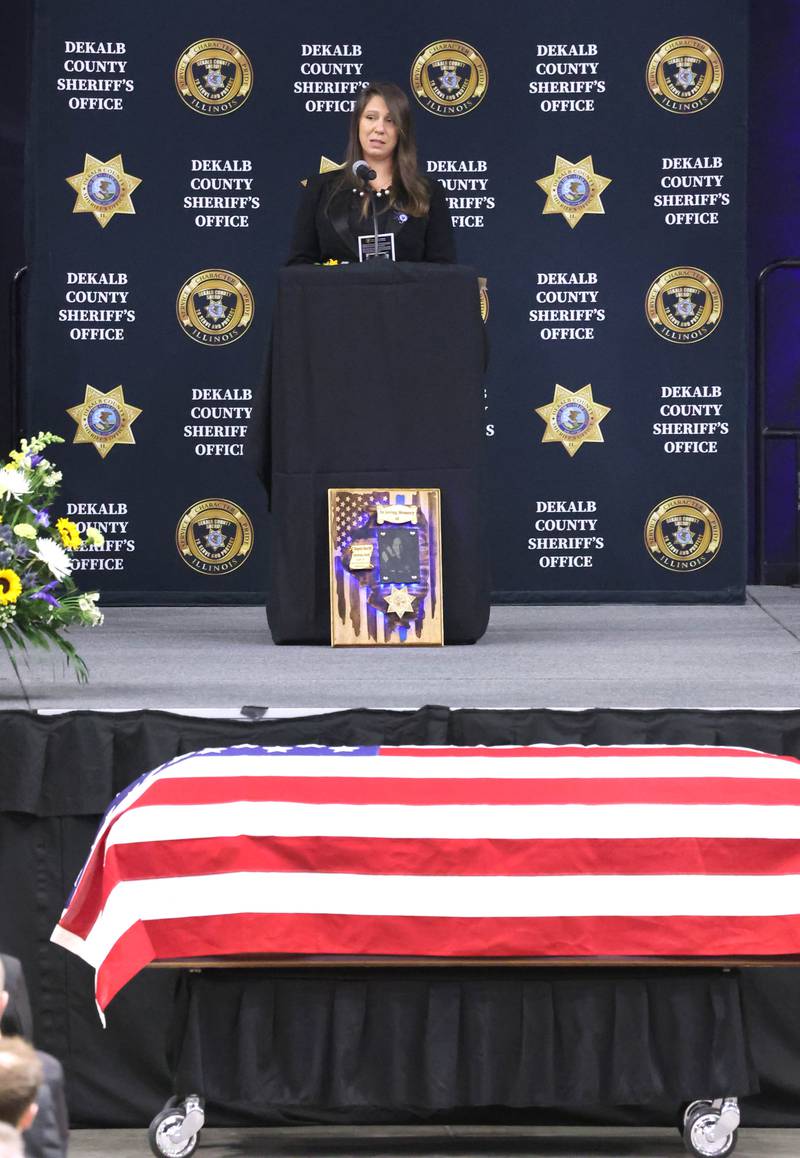 Bridgette Caporaso sister of the late DeKalb County Sheriff’s Deputy Christina Musil gives the eulogy near her sister’s flag-draped casket Thursday, April 4, 2024, during the visitation and funeral in the Convocation Center at Northern Illinois University. Musil, 35, was killed March 28 while on duty after a truck rear-ended her police vehicle in Waterman.