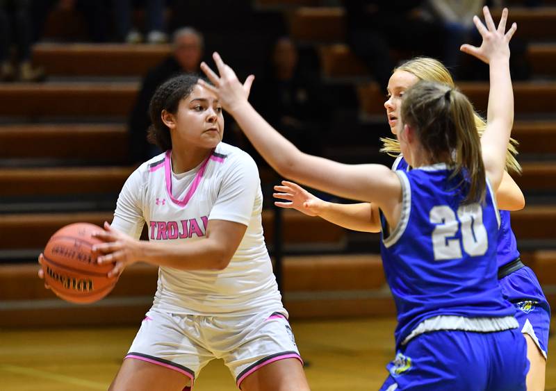 Downers Grove North's Kaitlyn Parker (left) looks to pass while double teamed by Lyons Township during a game on Jan. 30, 2024 at Downers Grove North High School in Downers Grove .