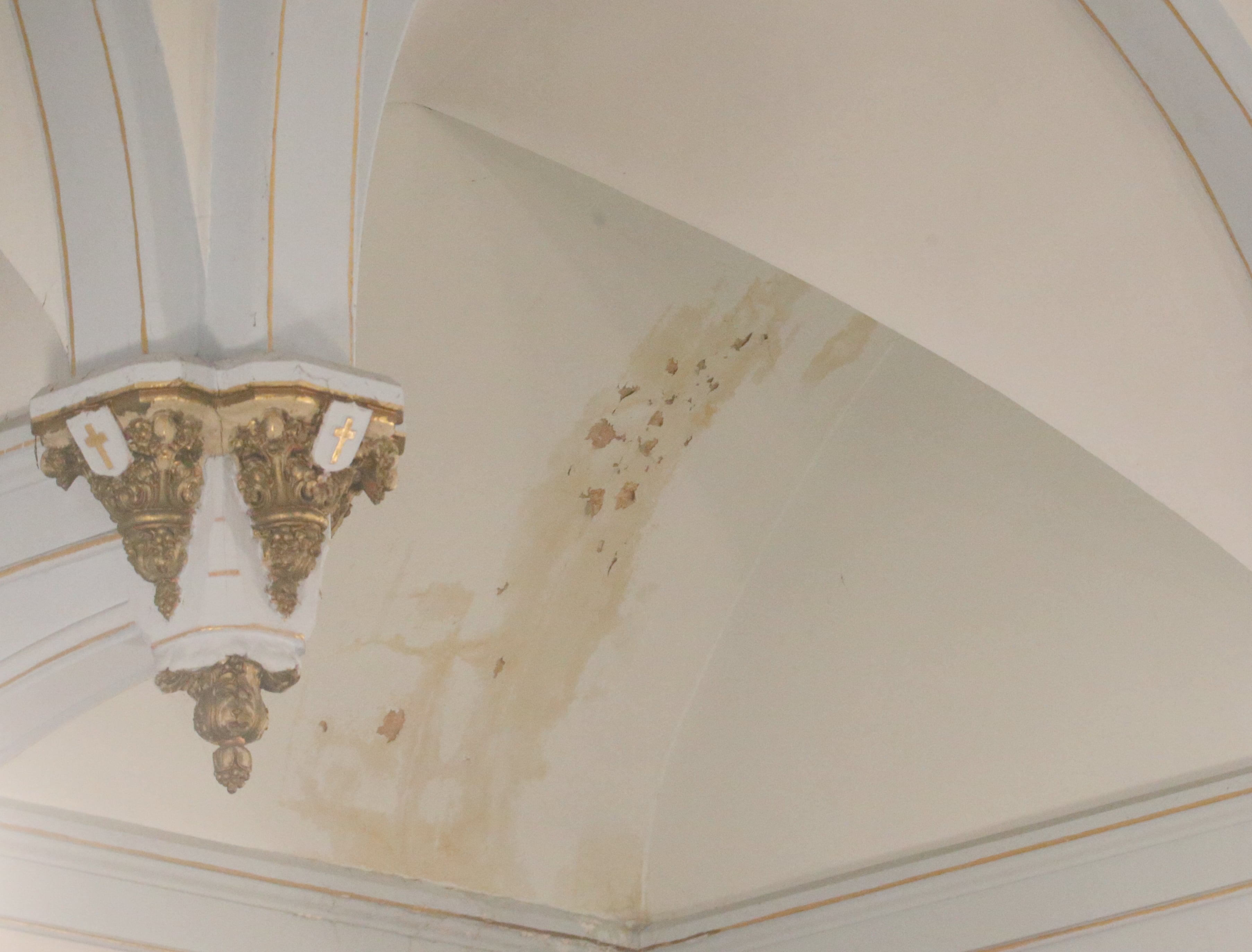 A stained ceiling and chipped paint are noticeable on the celing during the final Mass at St. Mary's Church on Thursday, Aug. 15, 2024 in Peru. The church was founded in 1867.