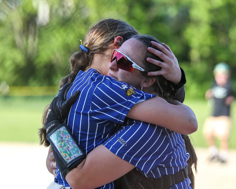Newark's Kodi Rizzo (20) and Newark's Danica Peshia (17) hug after defeating St. Edwards in their Class 1A Newark Regional final game. May 17th, 2024.