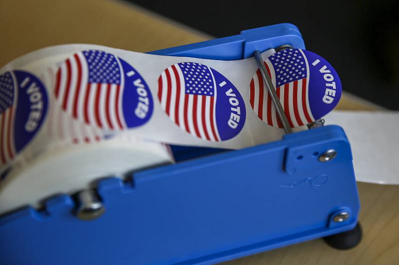 "I Voted" stickers sit on a table March 24 during early voting at the Inwood Athletic Club in Joliet. Election Day is Tuesday.