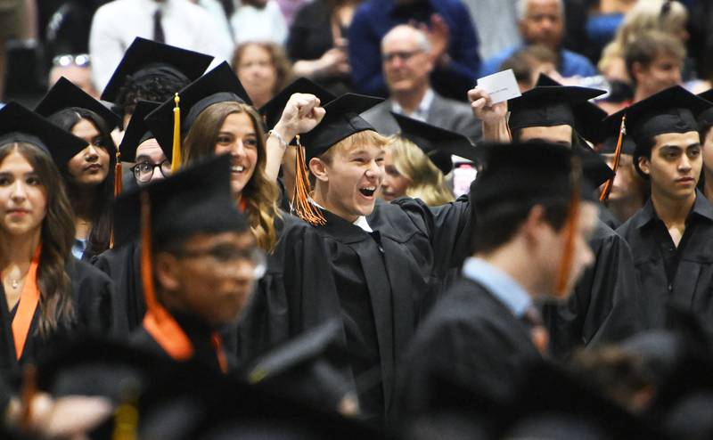 Wheaton Warrenville South senior Robert Turner cheers after seeing loved ones in the audience during the high school's graduation ceremony on Saturday, May 25, 2024 at the College of DuPage in Glen Ellyn.