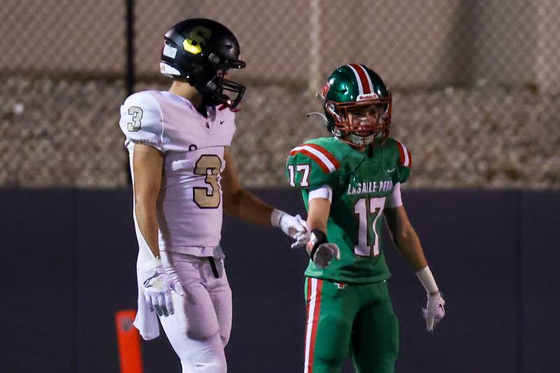 Carter York of Sycamore and Raphael Helming of L-P fist bump during game on Friday, October 11, 2024 at Howard Fellows Stadium in LaSalle.