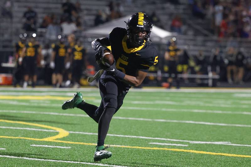 Joliet West’s Landon Mars takes a pass in for the touchdown against Yorkville on Friday, Sept. 13, 2024 in Joliet.