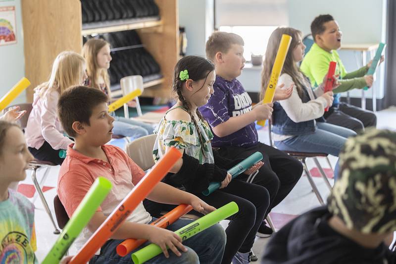 Students follow along a video that shows when each color Boomwhacker should be played.