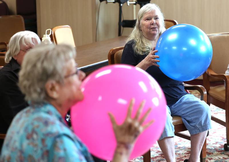 Barb City Manor residents Sharell Suiter (left) and Jean Benson get ready to throw the balls during an activity Tuesday, July 2, 2024, at the retirement home in DeKalb. Barb City Manor celebrated its 45th anniversary earlier this year.