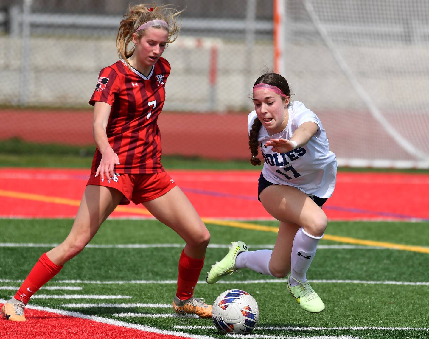 Hinsdale Central's Avery Edgewater (7) and Oswego East's Riley Gumm battle for the ball during a match on March, 30, 2024 at Hinsdale Central High School in Hinsdale.
