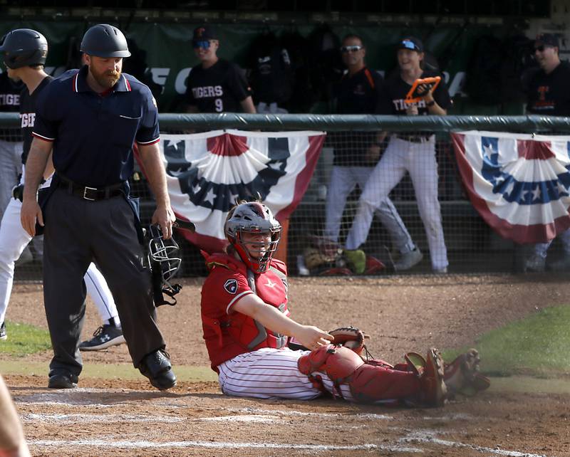 Deerfield's Ethan Platt argues that he got the runner out after Crystal Lake Central's Drew Welder scored during a Class 3A Grayslake Central sectional championship baseball game on Friday, May 31, 2024, at the Grayslake Central High School.