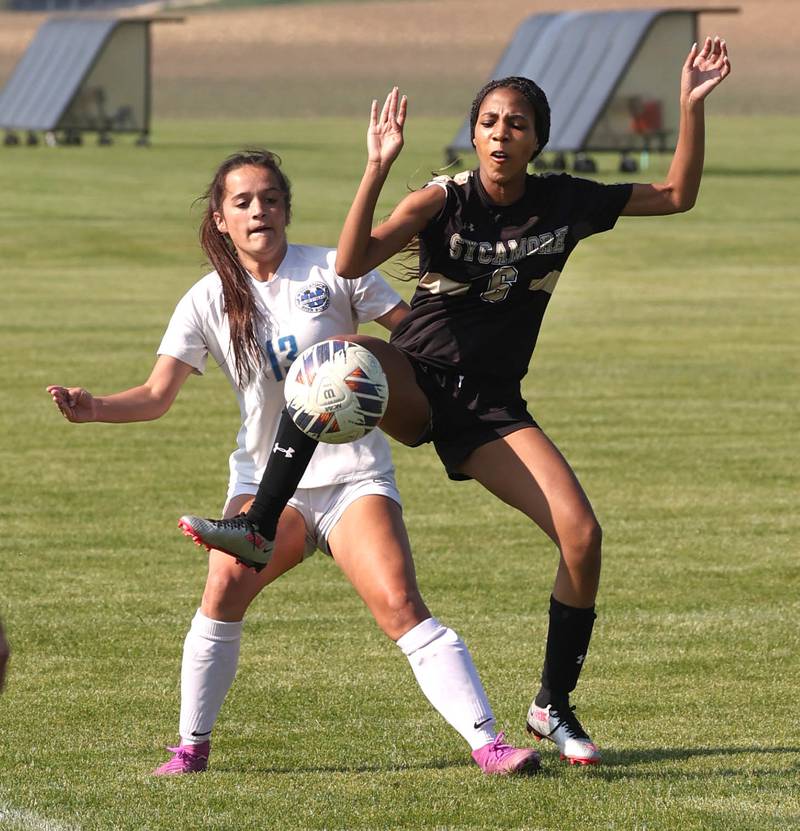 Sycamore's Tyanna Clark and Woodstock's Brooklyn Kentgen try to gain possession on a throw in during their Class 2A regional semifinal game Wednesday, May 15, 2024, at Kaneland High School in Maple Park.