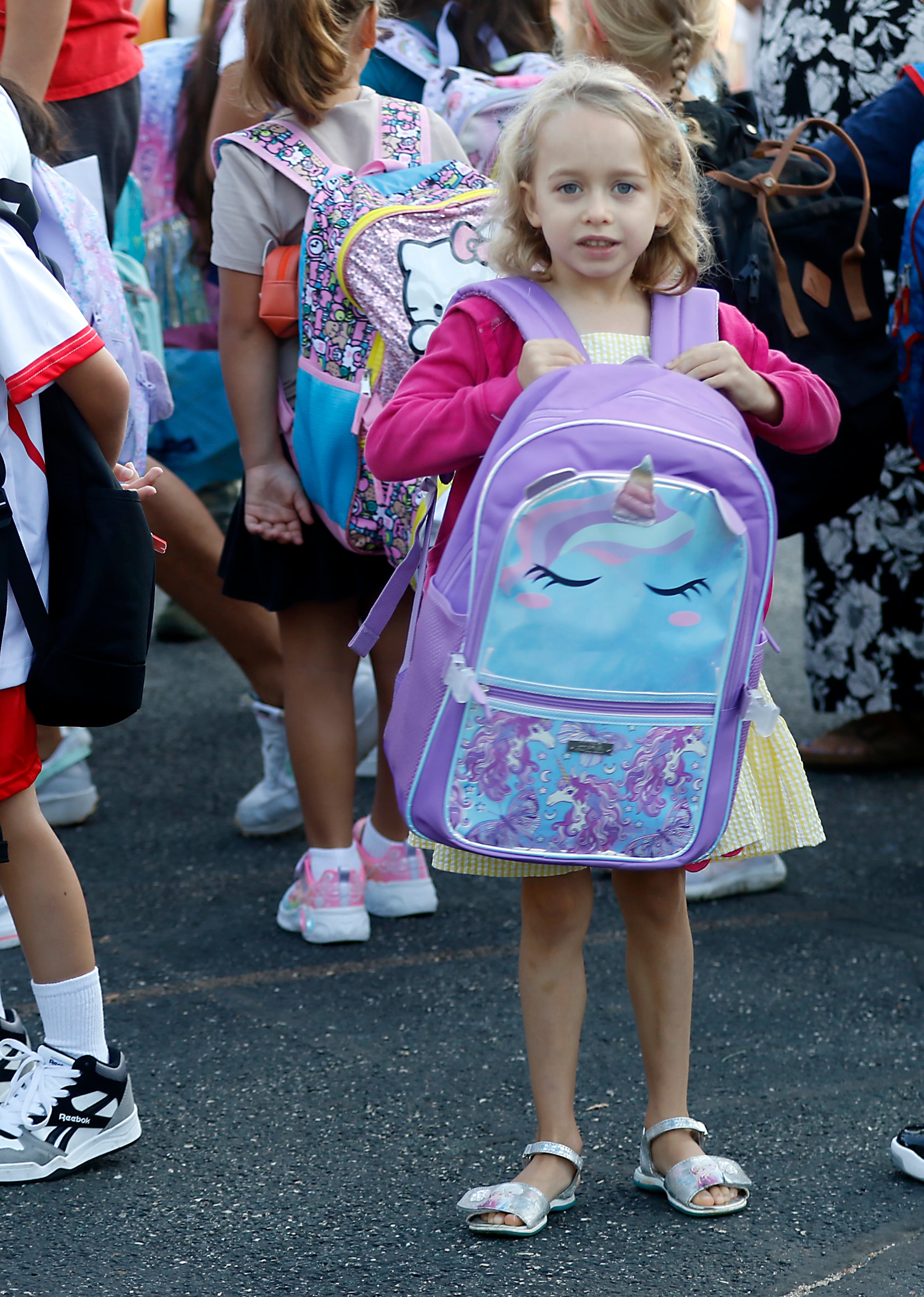 First-grader River Radclift waits for school to start with other students on the first day of school at Olson Elementary School in Woodstock on Wednesday, Aug. 14, 2024,