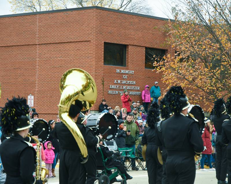 Spectators use a hill at the Kindred Hospital building to watch the Sycamore High School band march by during the Sycamore Pumpkin Festival parade in downtown Sycamore held on Sunday Oct. 29, 2023.
