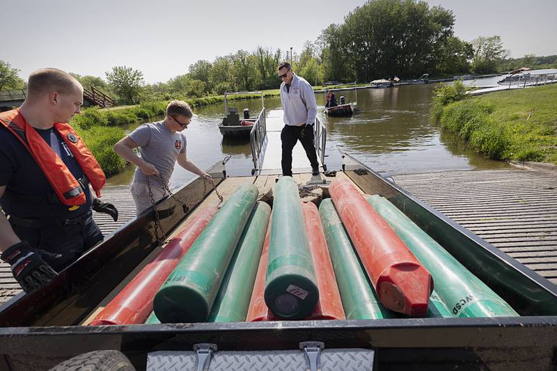 Rock Falls Deputy Fire Chief Kyle Sommers watches as firefighters Dylan Scudder (left), and Brayden Porter load up buoys for the next run Wednesday, May 15, 2024.