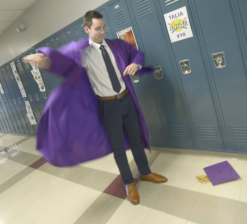 Ryan Stevenson quickly gets ready in the hallway at Mendota High School Saturday  minutes before the class of 2024 graduation ceremony.