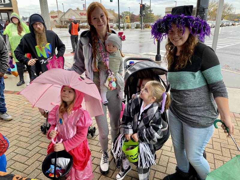 (From left) Azalea de la Cruz dressed as Princess Peach, Lexi Harris, Cole McLean, Scarlett McLean dressed as a zombie cheerleader and Kira McLean pose at the American Family Insurance booth while trick-or-treating in downtown DeKalb Thursday, Oct. 26, 2023 for the 26th annual Spooktacular hosted by the DeKalb Chamber of Commerce.