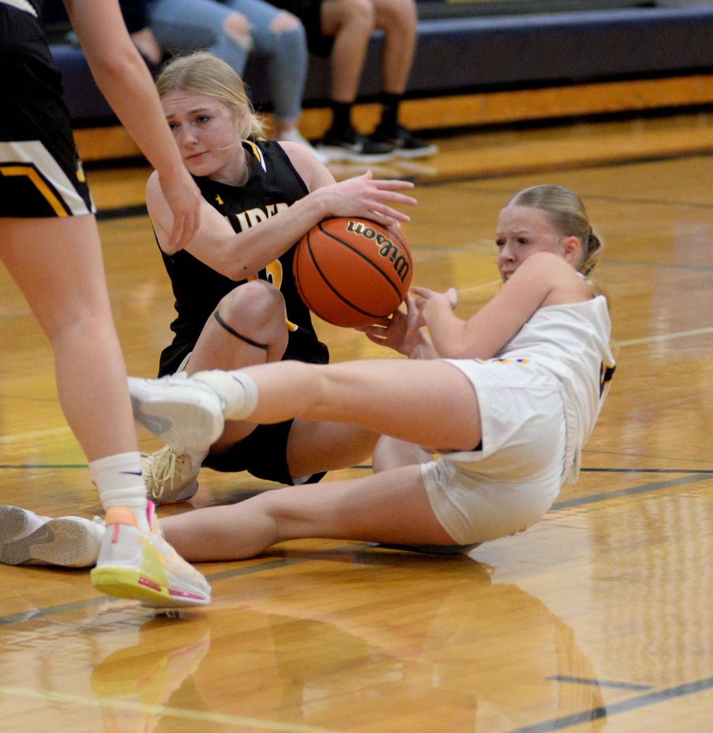 Polo's Carlee Grobe (right) and Ashton-Franklin Center's Cameryn Winterland (left) battle for a loose ball during a Wednesday, Jan. 3, 2023 game at Polo High School.